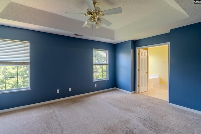 105 Songbird Ct, Chapin, SC 29036 - unfurnished bedroom featuring a textured ceiling, carpet, a tray ceiling, baseboards, and a ceiling fan