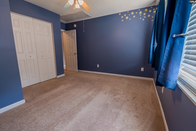 105 Songbird Ct, Chapin, SC 29036 - unfurnished bedroom with attic access, carpet flooring, baseboards, a closet, and a ceiling fan