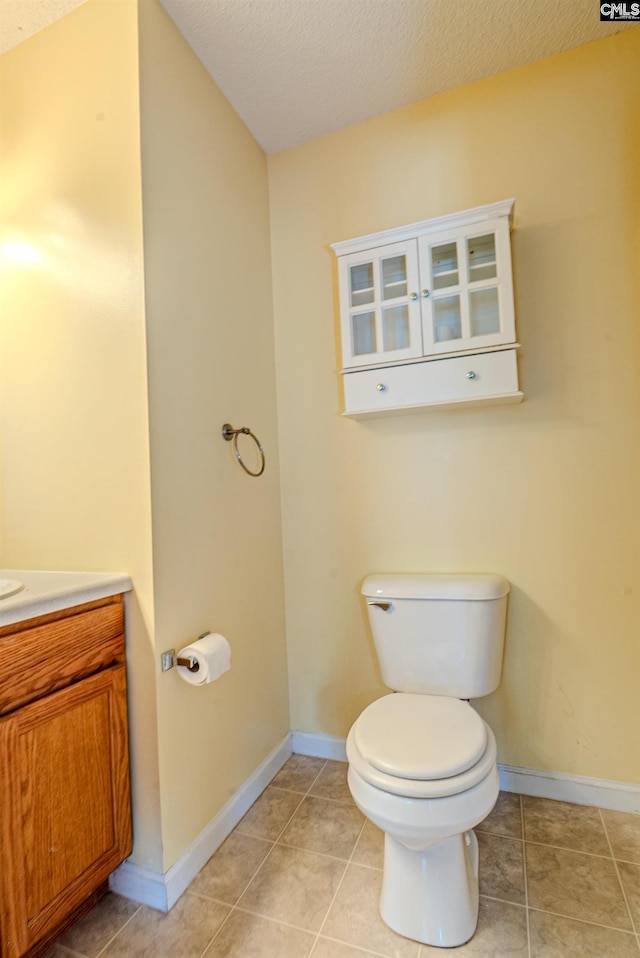 105 Songbird Ct, Chapin, SC 29036 - half bathroom featuring toilet, vanity, a textured ceiling, baseboards, and tile patterned flooring