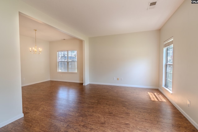 105 Songbird Ct, Chapin, SC 29036 - unfurnished room featuring plenty of natural light, dark wood-style floors, and a chandelier