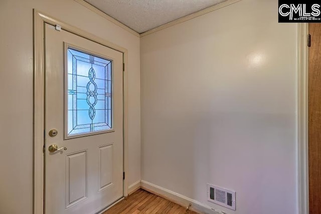 127 Lake Elizabeth Dr, Columbia, SC 29203 - doorway to outside with ornamental molding, light wood-type flooring, baseboards, and a textured ceiling