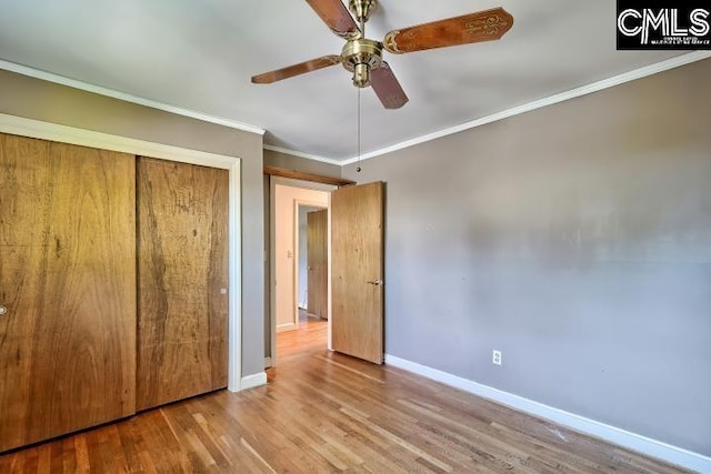 127 Lake Elizabeth Dr, Columbia, SC 29203 - unfurnished bedroom with baseboards, crown molding, wood finished floors, a closet, and ceiling fan