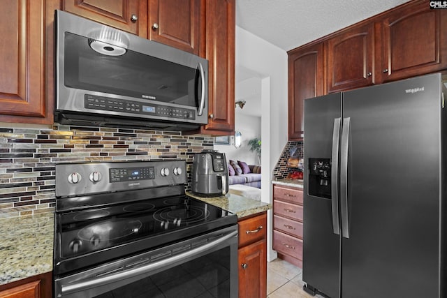 300 Green Rose, Columbia, SC 29229 - kitchen with appliances with stainless steel finishes, backsplash, light stone countertops, and light tile patterned flooring