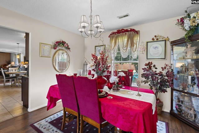 300 Green Rose, Columbia, SC 29229 - dining space with a chandelier, a textured ceiling, wood finished floors, and baseboards