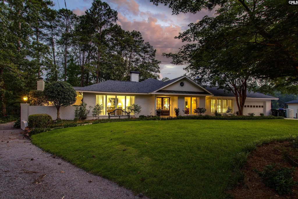 6137 Eastshore Rd, Columbia, SC 29206 - ranch-style house with a chimney, a yard, and a garage