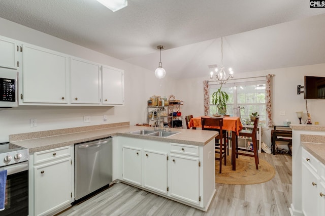 248 N High Duck Trl, Blythewood, SC 29016 - kitchen with appliances with stainless steel finishes, a sink, light wood-style flooring, a chandelier, and vaulted ceiling