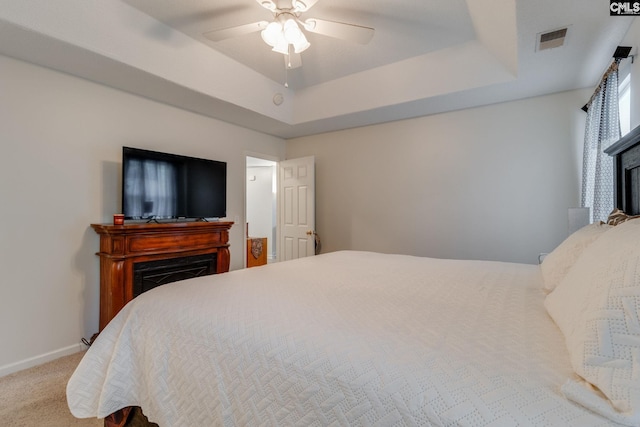 248 N High Duck Trl, Blythewood, SC 29016 - carpeted bedroom featuring a fireplace, a raised ceiling, baseboards, and ceiling fan
