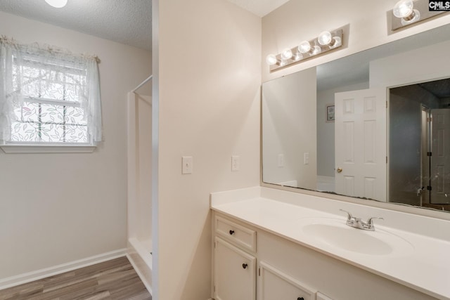 248 N High Duck Trl, Blythewood, SC 29016 - bathroom with vanity, wood finished floors, a shower, baseboards, and a textured ceiling