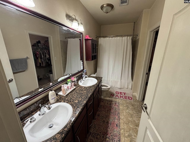 1085 Shop Rd Unit 117, Columbia, SC 29201 - bathroom featuring double vanity, shower / tub combo with curtain, a spacious closet, and tile patterned floors
