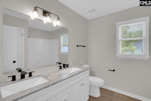 204 Sandcreek Dr, Winnsboro, SC 29180 - bathroom with double vanity, toilet, wood finished floors, a shower, and baseboards