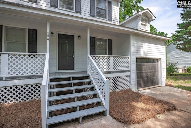 204 Sandcreek Dr, Winnsboro, SC 29180 - doorway to property featuring covered porch, concrete driveway, and a garage