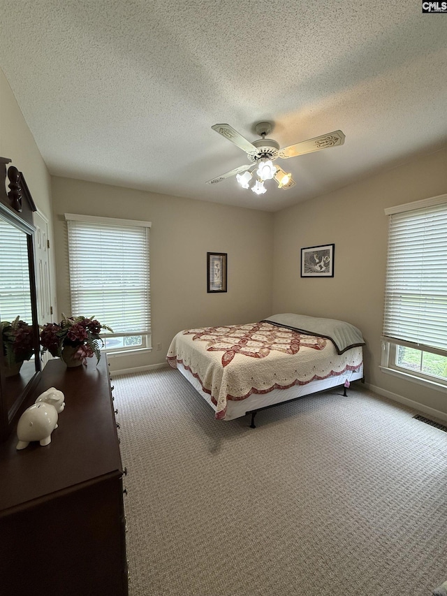 3270 Winchester Ln, Orangeburg, SC 29118 - carpeted bedroom featuring a textured ceiling, ceiling fan, and baseboards