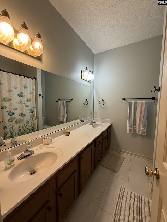 3270 Winchester Ln, Orangeburg, SC 29118 - full bath with toilet, tile patterned floors, double vanity, a textured ceiling, and baseboards