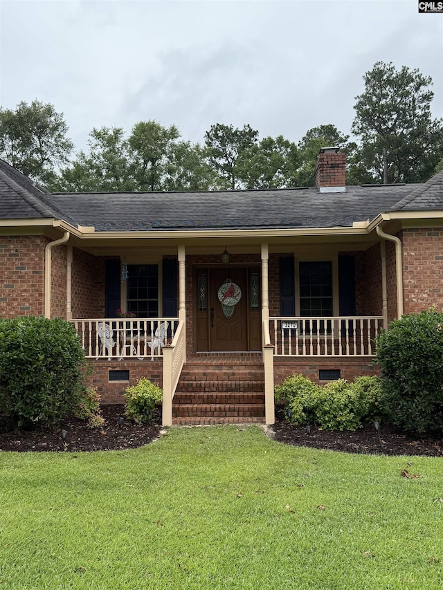 3270 Winchester Ln, Orangeburg, SC 29118 - view of front of home with a porch, brick siding, a front yard, a chimney, and roof with shingles