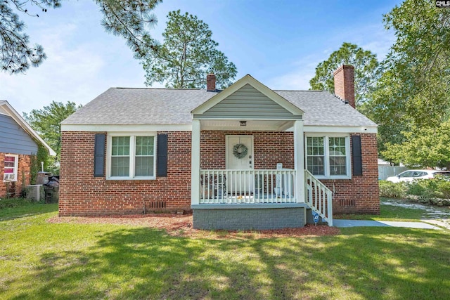 1321 C Ave, West Columbia, SC 29169 - bungalow-style house with brick siding, a front yard, a chimney, and a shingled roof