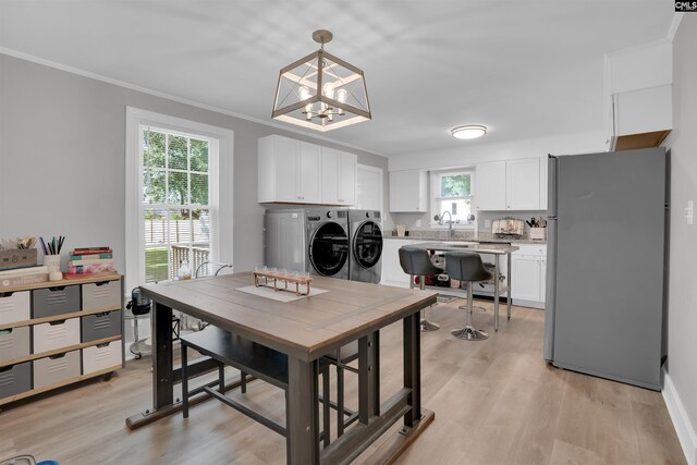 1321 C Ave, West Columbia, SC 29169 - dining space with washer and clothes dryer, plenty of natural light, crown molding, and light wood-style floors
