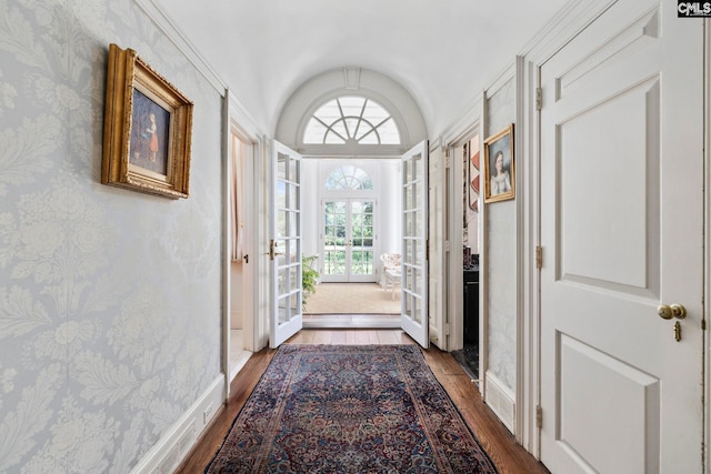 1100 W Carolina Ave, Hartsville, SC 29550 - doorway with hardwood / wood-style flooring, lofted ceiling, wallpapered walls, and baseboards