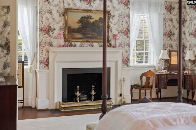 1100 W Carolina Ave, Hartsville, SC 29550 - bedroom with wallpapered walls, a fireplace, and wood finished floors