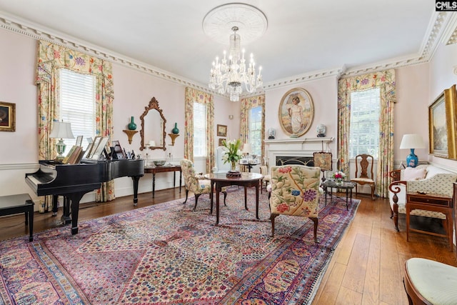 1100 W Carolina Ave, Hartsville, SC 29550 - living area featuring healthy amount of natural light, wood-type flooring, ornamental molding, a chandelier, and a fireplace