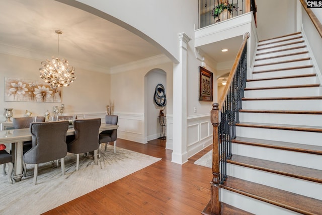 535 New Cut Ln, Blythewood, SC 29016 - dining room with arched walkways, stairway, wood finished floors, ornamental molding, and wainscoting