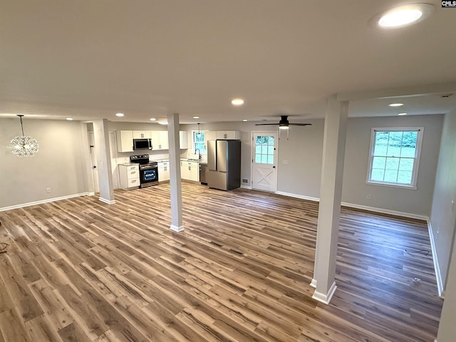 104 Farmington Rd, Columbia, SC 29223 - unfurnished living room with baseboards, recessed lighting, wood finished floors, and a sink