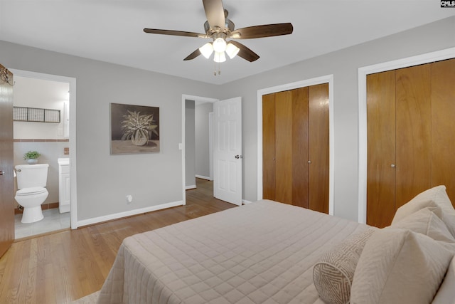 344 Rawls Dr, Leesville, SC 29070 - bedroom featuring two closets, connected bathroom, wood finished floors, and a ceiling fan