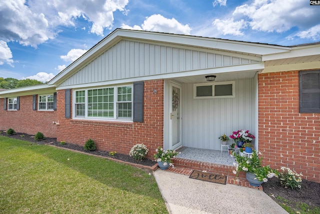 344 Rawls Dr, Leesville, SC 29070 - doorway to property with board and batten siding, a yard, and brick siding
