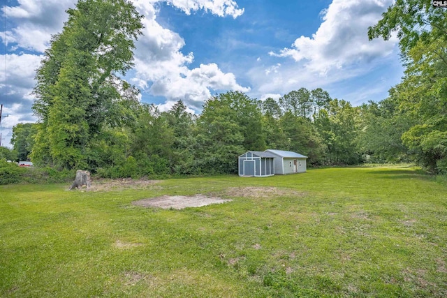 344 Rawls Dr, Leesville, SC 29070 - view of grassy yard featuring an outbuilding, a wooded view, and a pole building