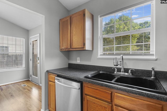 309 Pebble Creek Ct, West Columbia, SC 29170 - kitchen with dishwasher, light wood-type flooring, dark countertops, and brown cabinets