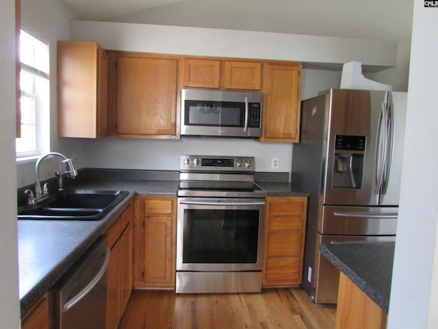 309 Pebble Creek Ct, West Columbia, SC 29170 - kitchen with appliances with stainless steel finishes, healthy amount of natural light, brown cabinets, and light wood-style floors