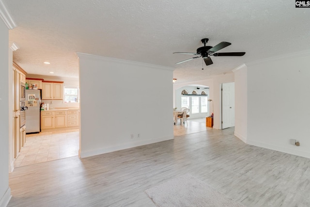 2117 Togetherness Way, Mcbee, SC 29101 - unfurnished living room with ornamental molding, arched walkways, ceiling fan, light wood-type flooring, and a textured ceiling