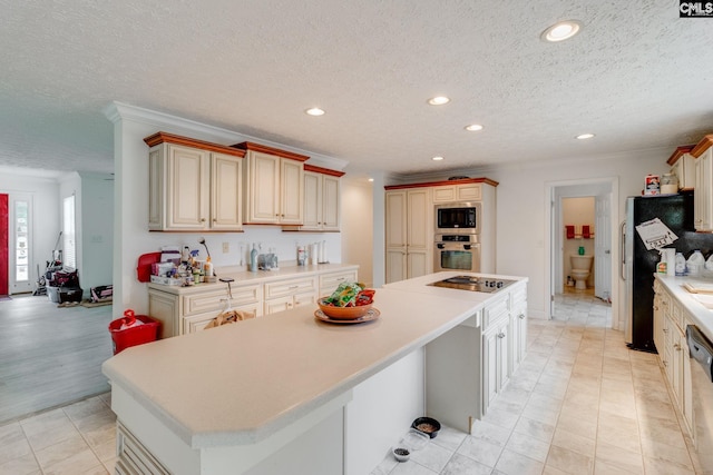 2117 Togetherness Way, Mcbee, SC 29101 - kitchen featuring appliances with stainless steel finishes, crown molding, recessed lighting, a kitchen island, and cream cabinetry