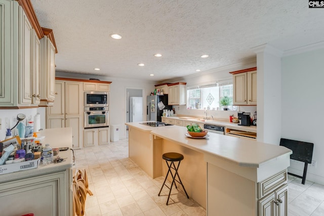 2117 Togetherness Way, Mcbee, SC 29101 - kitchen with appliances with stainless steel finishes, cream cabinets, ornamental molding, a kitchen island, and recessed lighting