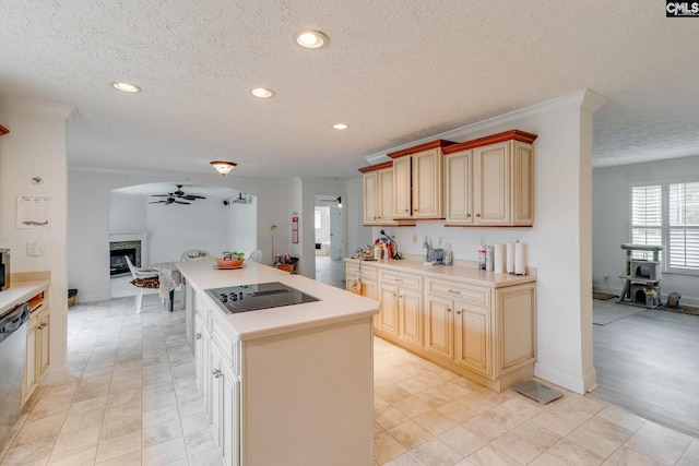 2117 Togetherness Way, Mcbee, SC 29101 - kitchen featuring black electric stovetop, ceiling fan, a textured ceiling, a glass covered fireplace, and light countertops