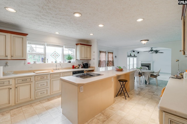 2117 Togetherness Way, Mcbee, SC 29101 - kitchen with cream cabinets, healthy amount of natural light, a center island, ornamental molding, and a textured ceiling