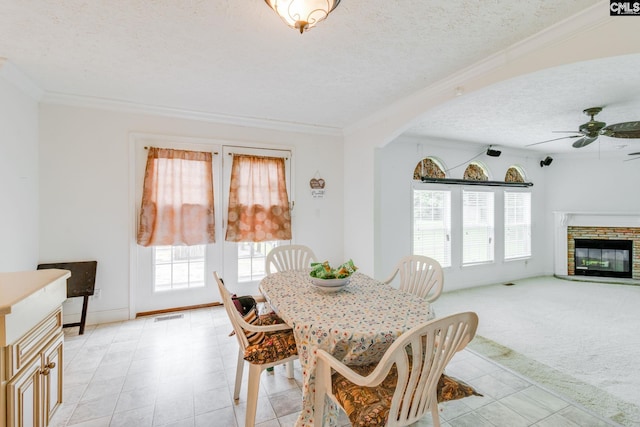 2117 Togetherness Way, Mcbee, SC 29101 - dining room with a textured ceiling, ornamental molding, plenty of natural light, ceiling fan, and a stone fireplace