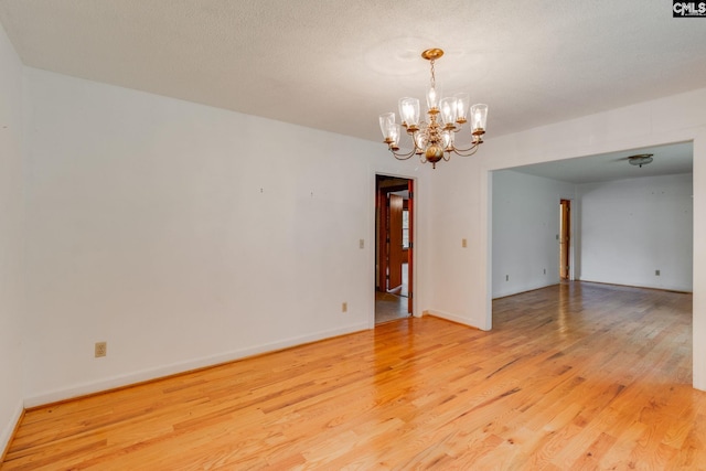 2117 Togetherness Way, Mcbee, SC 29101 - spare room featuring light wood-style flooring and a chandelier