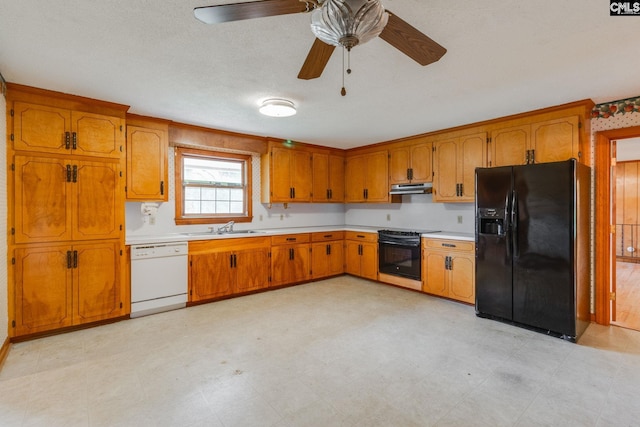 2117 Togetherness Way, Mcbee, SC 29101 - kitchen featuring black appliances, under cabinet range hood, brown cabinetry, and light countertops