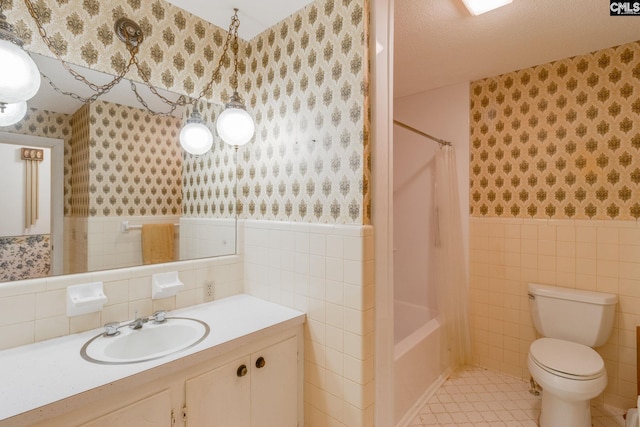2117 Togetherness Way, Mcbee, SC 29101 - bathroom with wallpapered walls, tile walls, wainscoting, vanity, and shower / bath combo