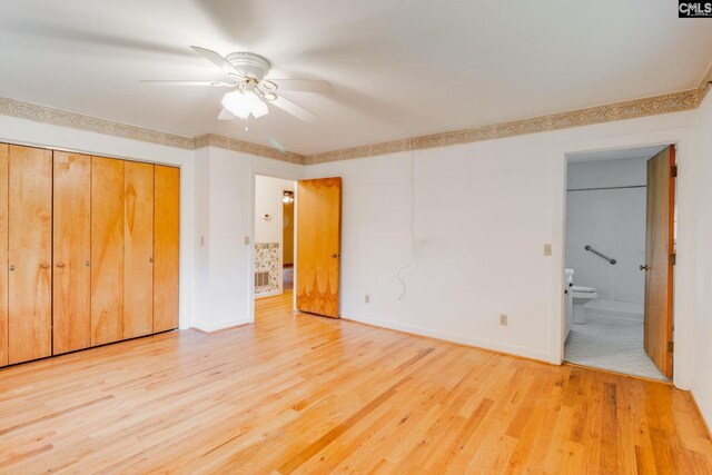2117 Togetherness Way, Mcbee, SC 29101 - unfurnished bedroom featuring wood finished floors, connected bathroom, a ceiling fan, and a closet