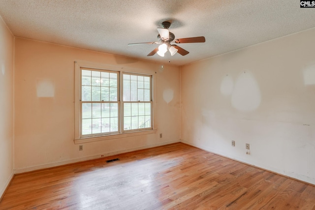 2117 Togetherness Way, Mcbee, SC 29101 - empty room featuring a textured ceiling, wood finished floors, and ceiling fan