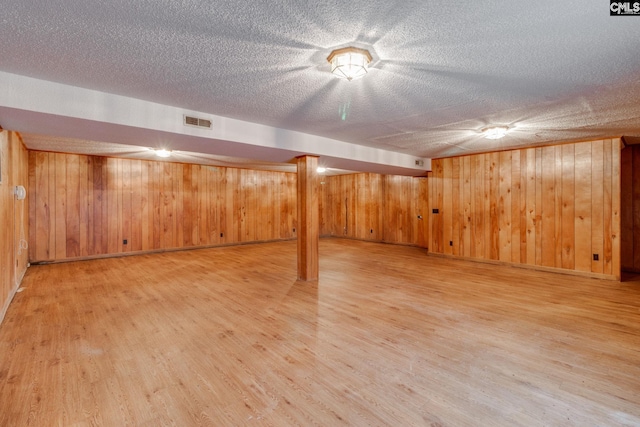 2117 Togetherness Way, Mcbee, SC 29101 - finished basement with light wood-type flooring, a textured ceiling, and wood walls
