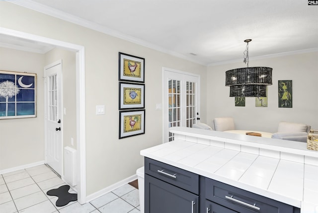 152 Carlyle Cir, Columbia, SC 29206 - kitchen featuring light tile patterned floors, crown molding, tile countertops, hanging light fixtures, and french doors