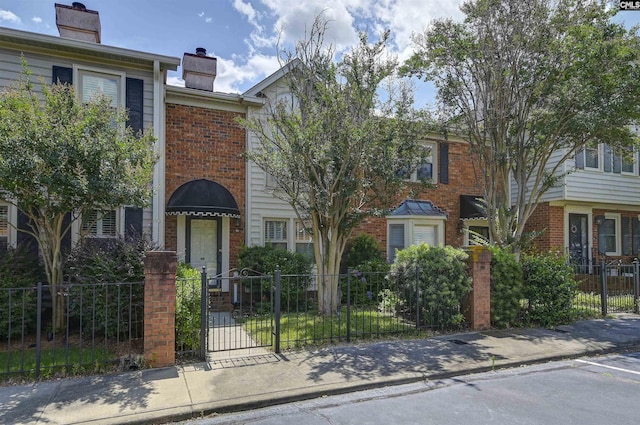 152 Carlyle Cir, Columbia, SC 29206 - townhome / multi-family property with brick siding, a fenced front yard, a chimney, and a gate
