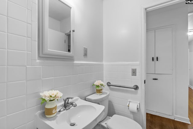 1409 Hazel St, Cayce, SC 29033 - bathroom featuring tile walls, wood finished floors, and a wainscoted wall