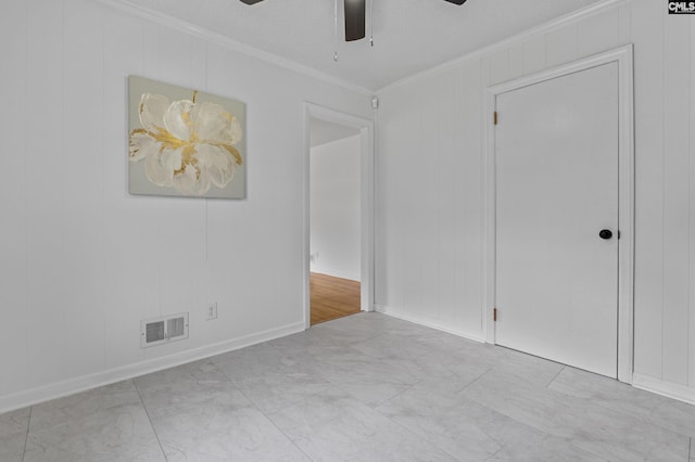 1409 Hazel St, Cayce, SC 29033 - spare room with ornamental molding, ceiling fan, and marble look tiles