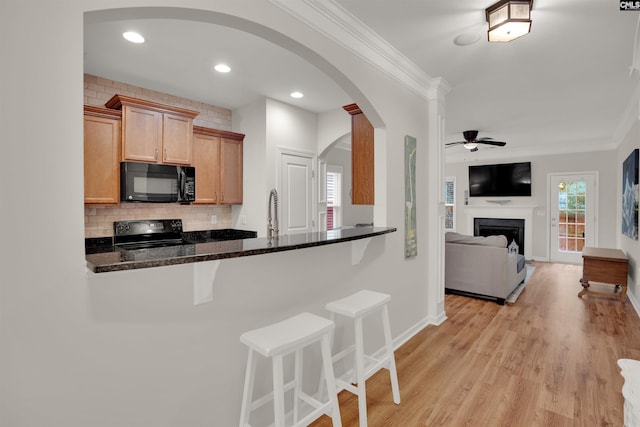 330 Lanyard Ln, Chapin, SC 29036 - kitchen with black appliances, ornamental molding, ceiling fan, a kitchen bar, and backsplash