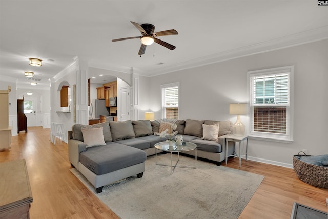 330 Lanyard Ln, Chapin, SC 29036 - living room with arched walkways, ornamental molding, a ceiling fan, light wood-style flooring, and ornate columns