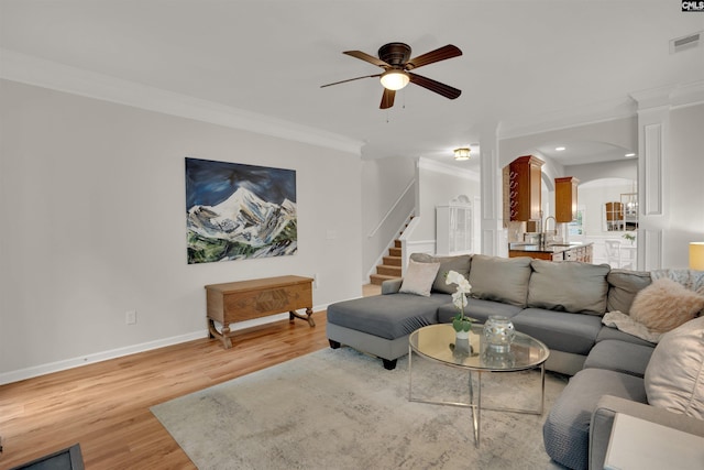 330 Lanyard Ln, Chapin, SC 29036 - living area with arched walkways, a ceiling fan, light wood-type flooring, ornamental molding, and stairs