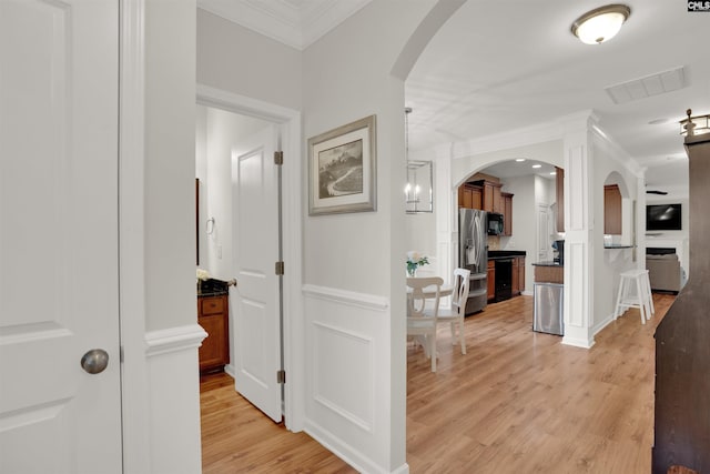 330 Lanyard Ln, Chapin, SC 29036 - hall with crown molding, light wood-style flooring, arched walkways, and wainscoting